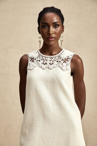 A short tweed mini dress with embroidery details and cut out sections featuring a feminine design in Beatrice style