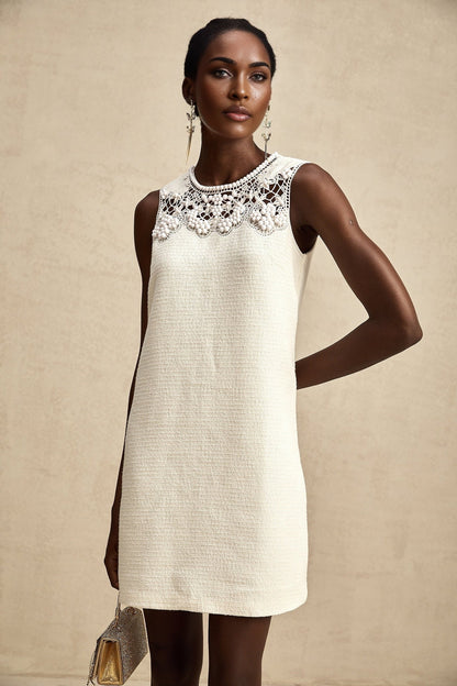 A short tweed mini dress with embroidery details and cut out sections