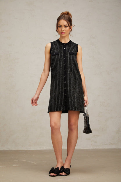 A short black knit mini dress with vertical stripes made of sequins featuring a Zelda design