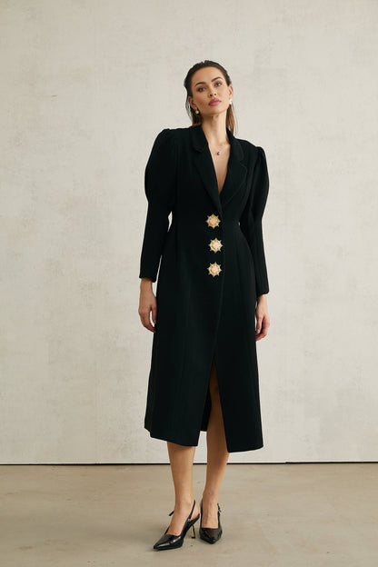 A black long single breasted coat by Aelle