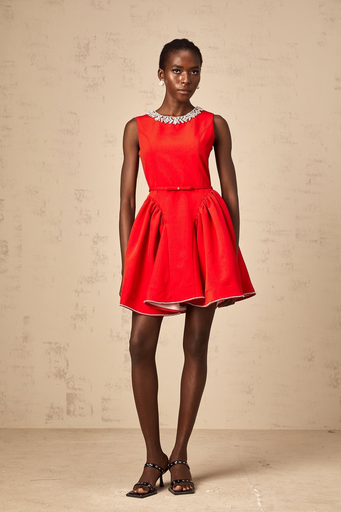 A red mini dress with pleated fabric and embellishments named Leonie