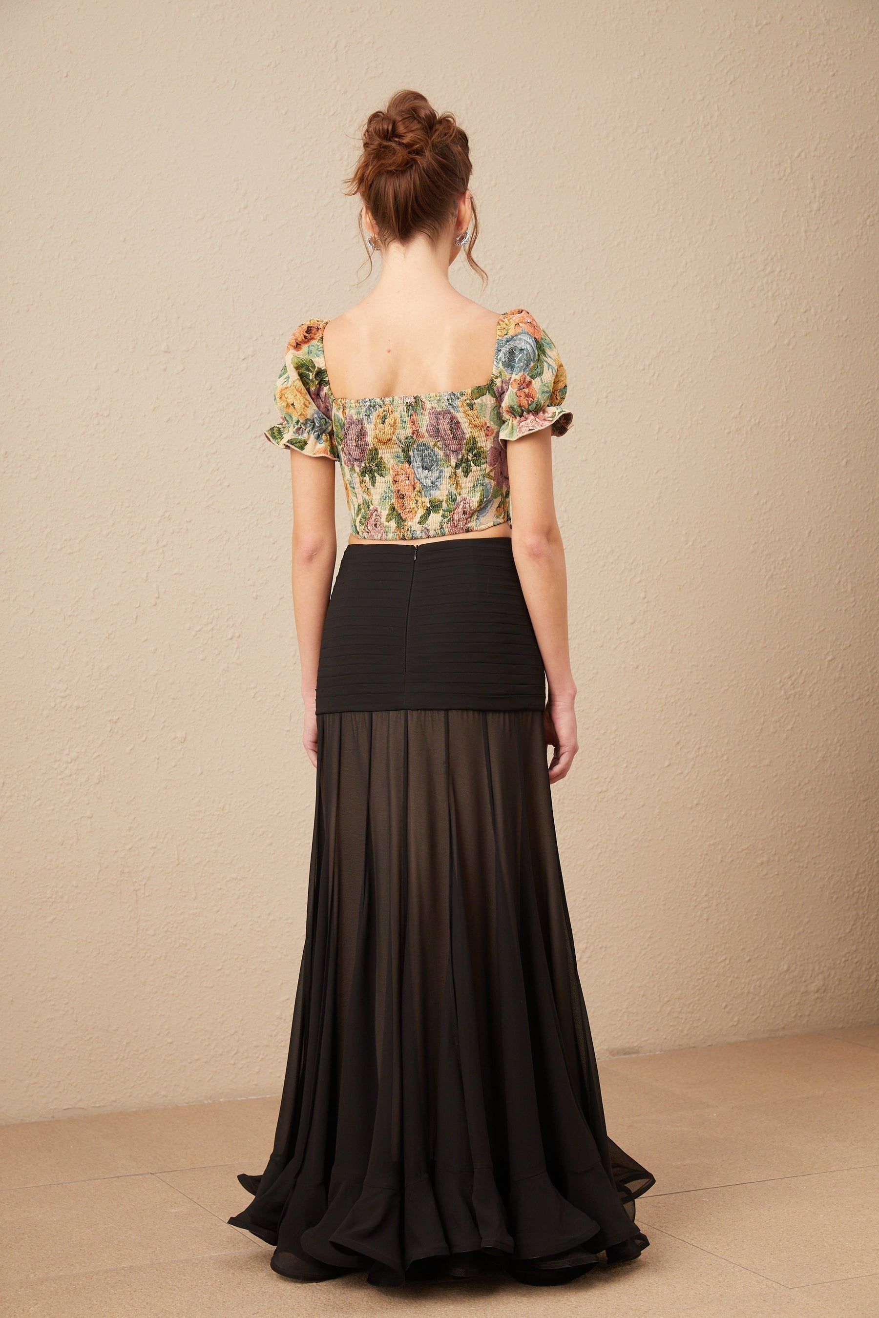 A cropped top with a floral print pattern in jacquard fabric named Constance featuring a colorful design on a textured background