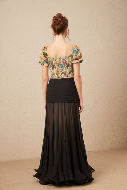 A cropped top with a floral print pattern in jacquard fabric named Constance featuring a colorful design on a textured background