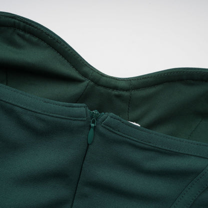 A green maxi dress with corsetstyle bodice featuring ribbon designs and a long flowing skirt