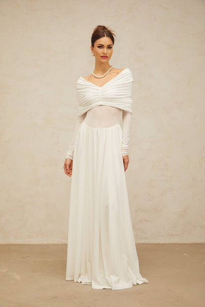 A white long maxi dress with ruched detailing and draped elements on a female model