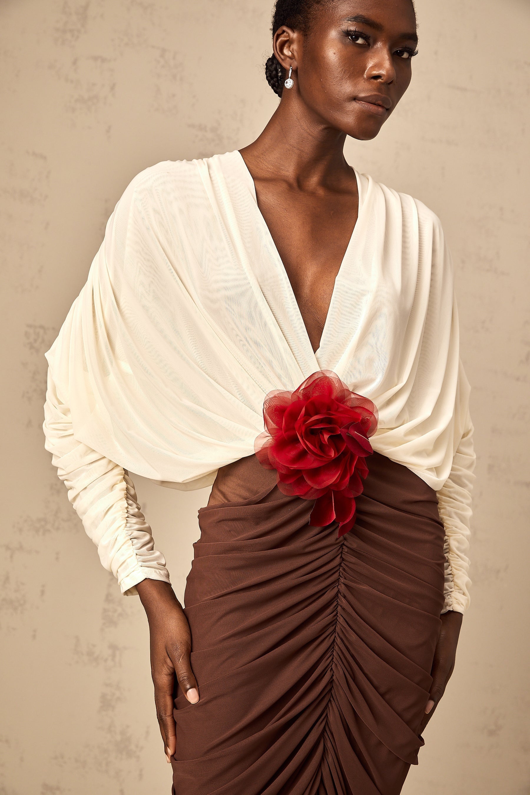 A midi dress with ruched details featuring a color block design and a decorative flower brooch named Leontine