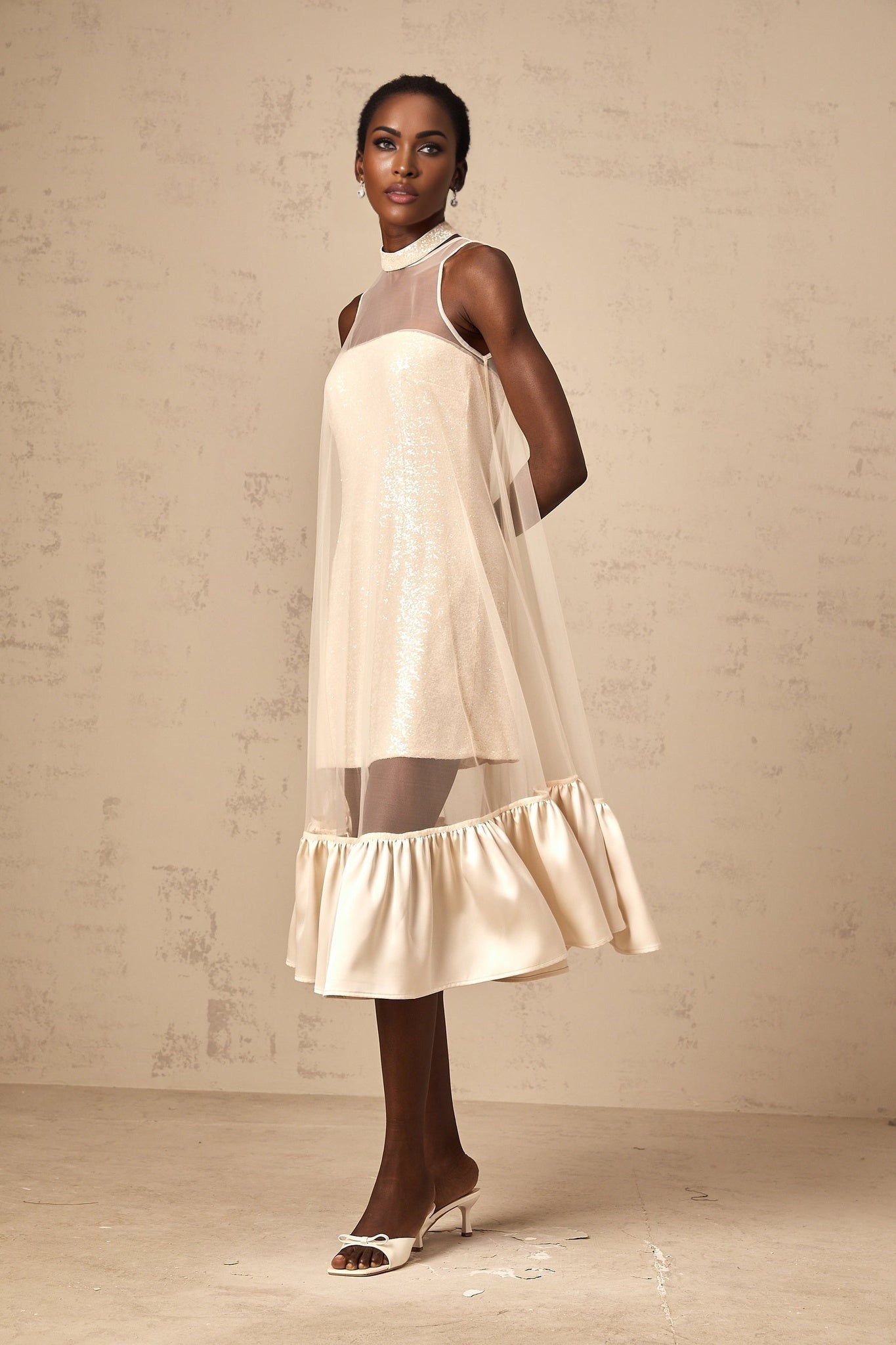 A layered midi dress with a tulle panel and sequin embellishments named Josette featuring a combination of shimmering fabric and delicate tulle overlay