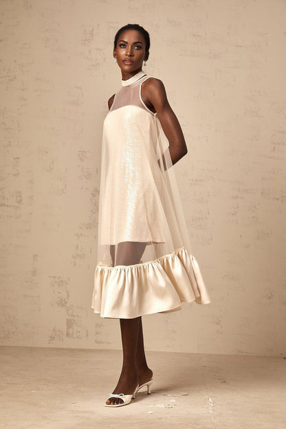 A layered midi dress with a tulle panel and sequin embellishments named Josette featuring a combination of shimmering fabric and delicate tulle overlay