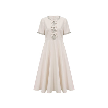 White midi dress with crystalaccented bow detail and Cassiopeia design