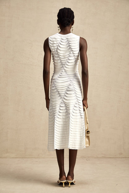 Woman wearing a midi length dress with snake pattern design featuring godet panels for a flared silhouette