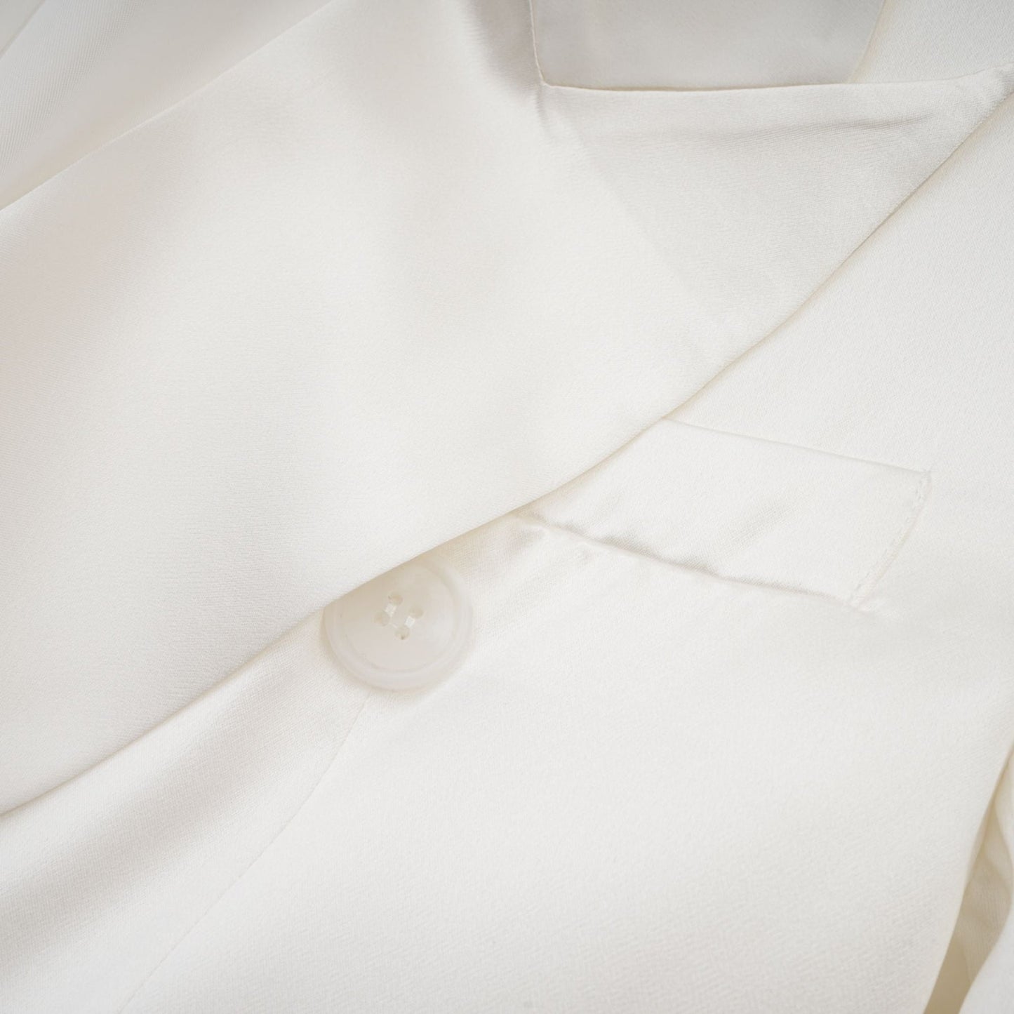 A white doublebreasted blazer named Sylvie on a plain background