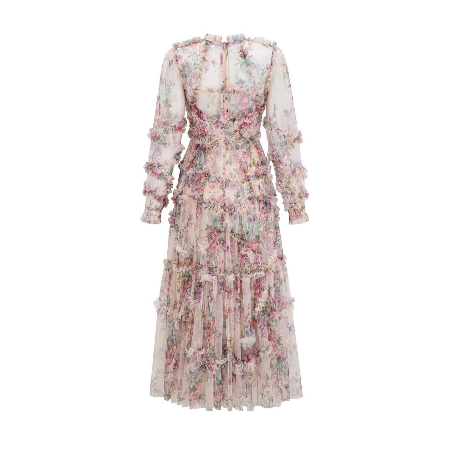 A woman wearing a floral patterned midi dress with ruffled details and a tulle skirt standing in a relaxed pose