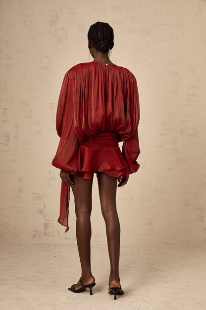 A red mini dress with full pleats and ruffles named Eugenie