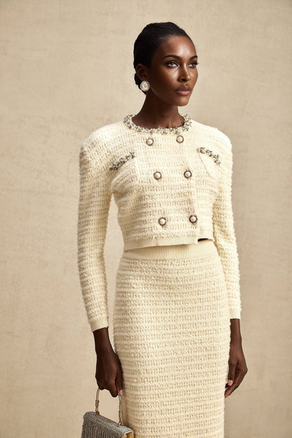 Woman wearing matching knit cardigan and skirt set with embellishments named Justine