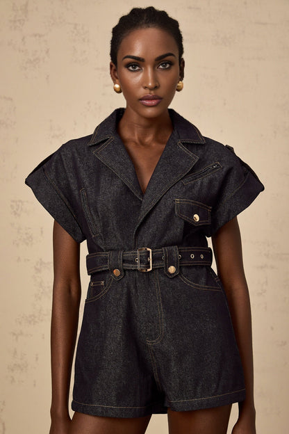 Woman wearing light blue denim playsuit with belt and short sleeves Chloé brand summer fashion outfit