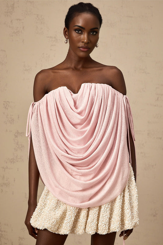 Woman wearing a pink offshoulder top with ruched detailing