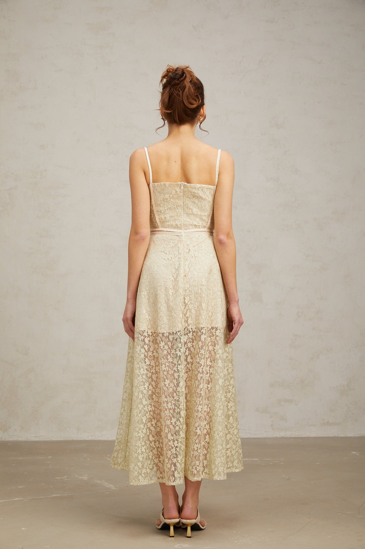 A light green midi dress with floral embroidery detailing named Yasmine