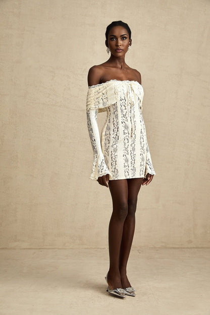 A neutral colored mini dress with floral lace pattern and flared cuffs named Émeline