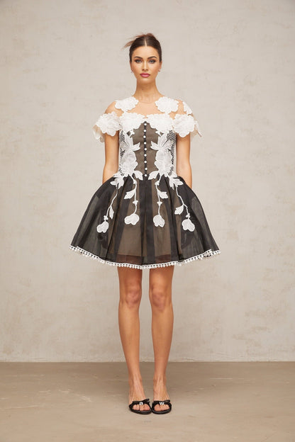 A short colorblocked mini dress with floral embroidery details featuring a mix of contrasting colors and a feminine silhouette