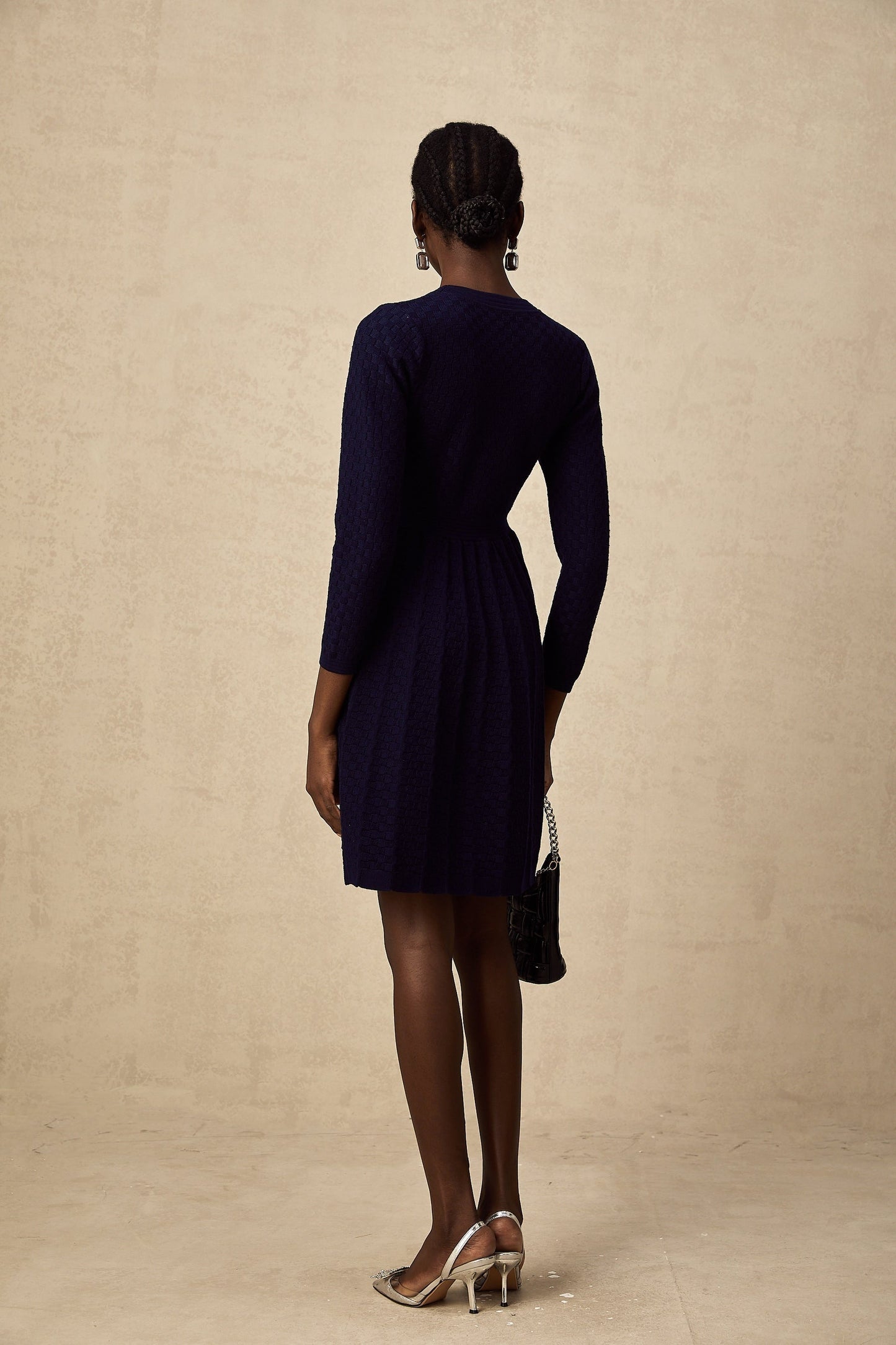 A navy blue mini dress with a basket weave texture featuring a short length and likely a fitted silhouette
