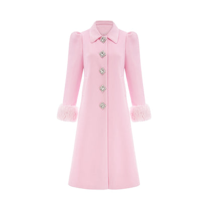 A pink faux fur overcoat named Louisette shown on a mannequin or model against a plain background