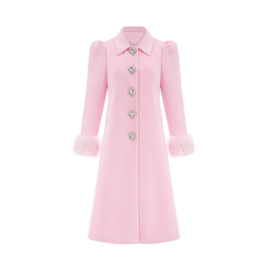 A pink faux fur overcoat named Louisette shown on a mannequin or model against a plain background