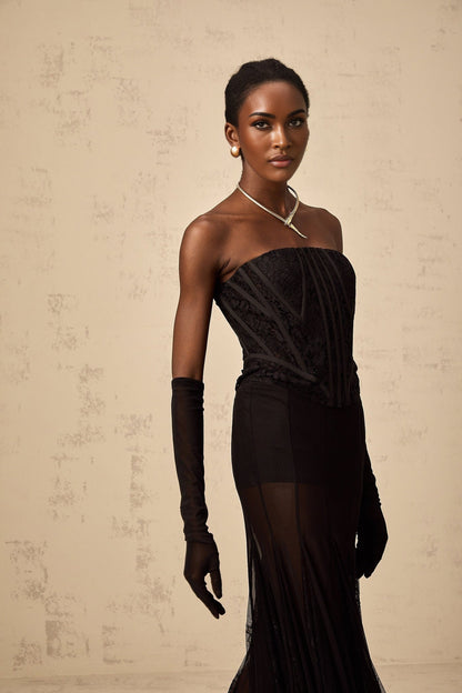 Woman wearing black floral lace corset skirt and gloves matching set Violaine style