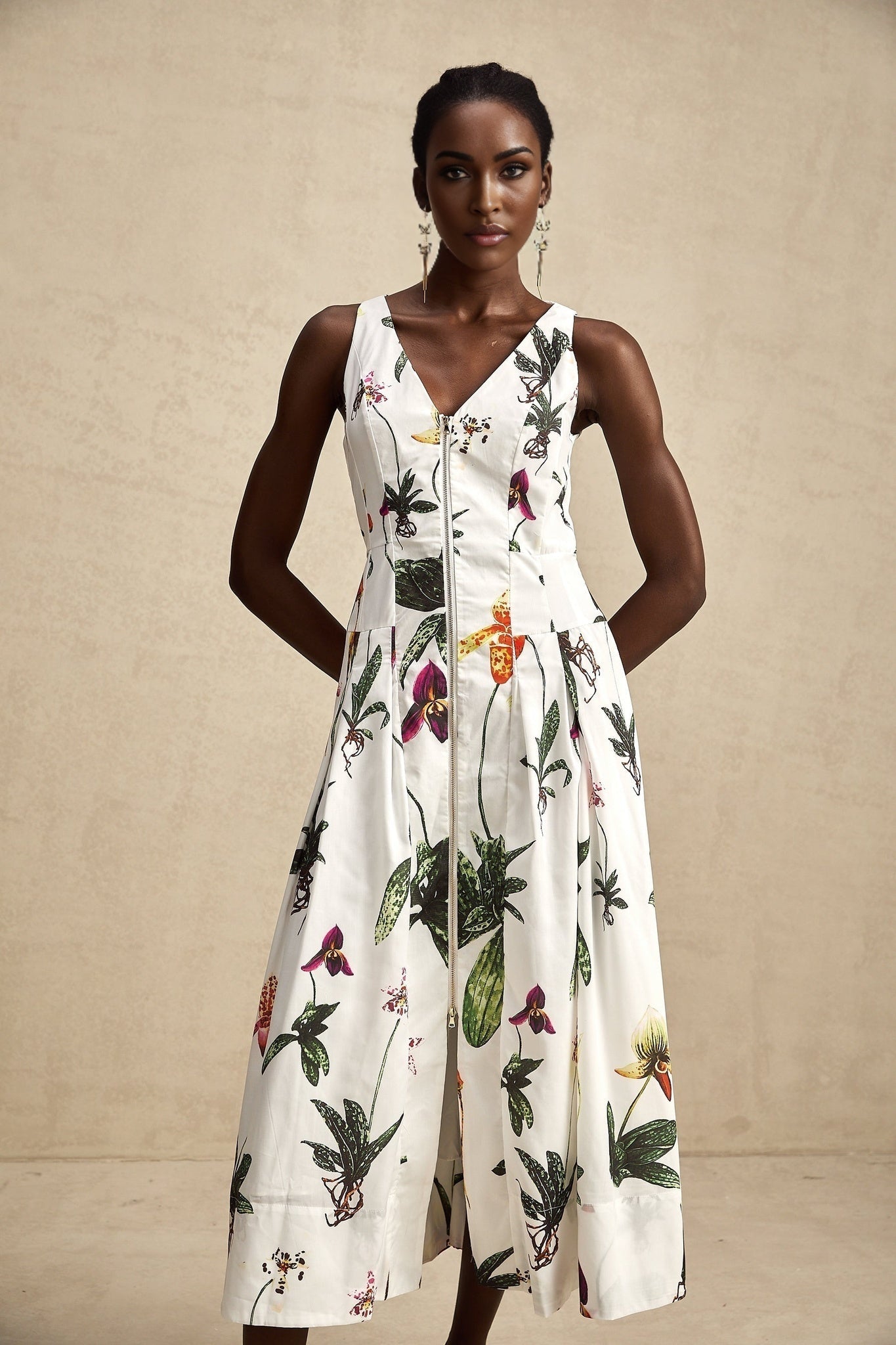 A floral print midi dress with a vneck made from poplin fabric featuring the Magali design