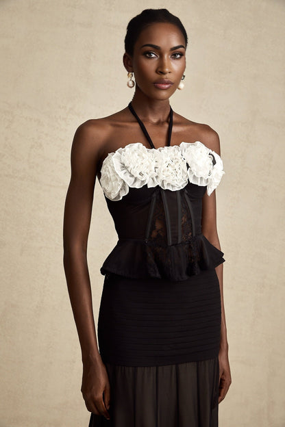 A black corset top with faux flower lace design featuring a structured bodice and delicate floral pattern