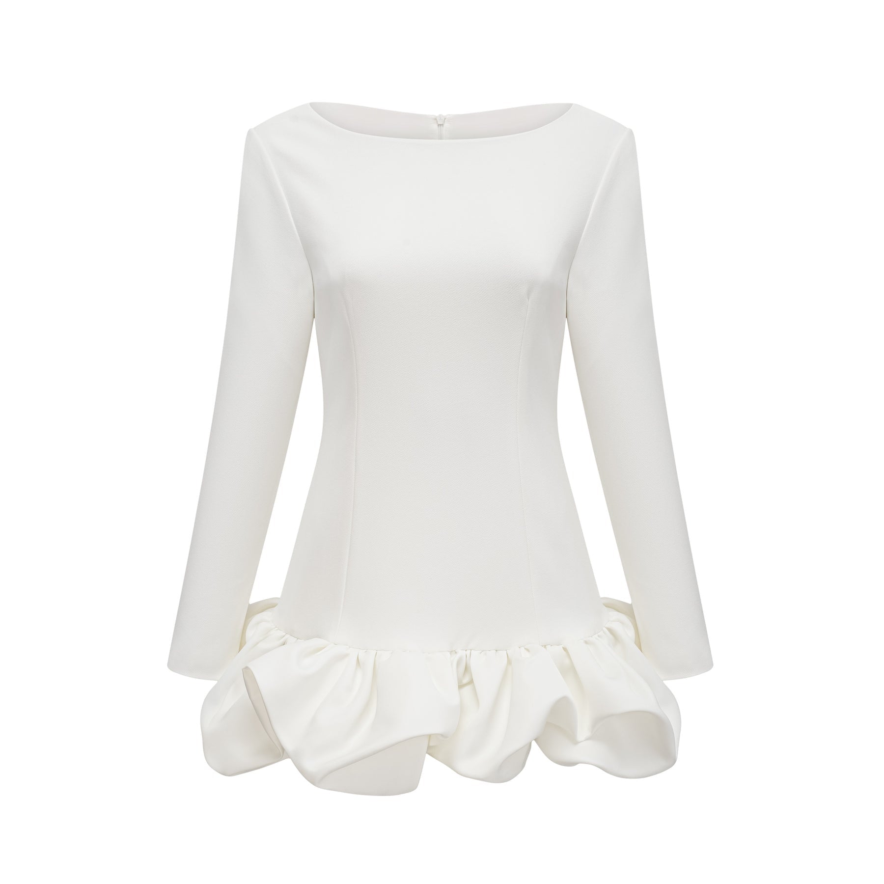 Young woman wearing a white mini dress with a bubble skirt and short sleeves standing against a plain background