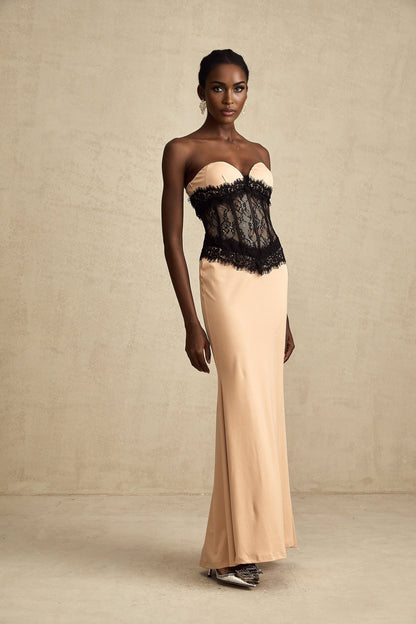 A long white offshoulder maxi dress with lace panels and a corsetstyle bodice featuring a fitted waist and flowing skirt