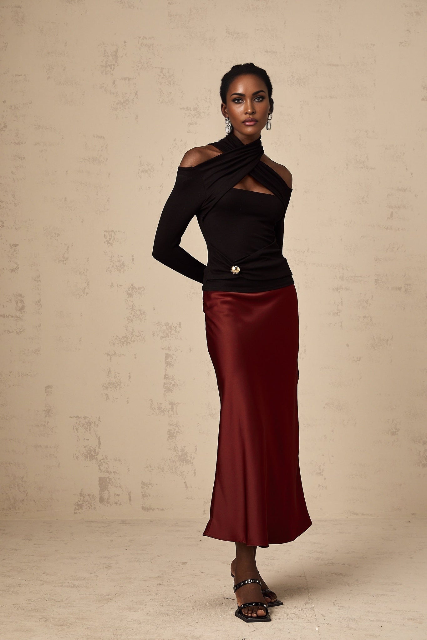 A black sleeveless top with ruched detailing made from stretchy jersey fabric