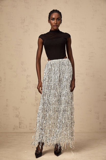 A woman wearing a twotone matching set consisting of a corsetstyle top and skirt in the Virginie style The top is fitted with a structured bodice while the skirt complements the look with a coordinating color and design