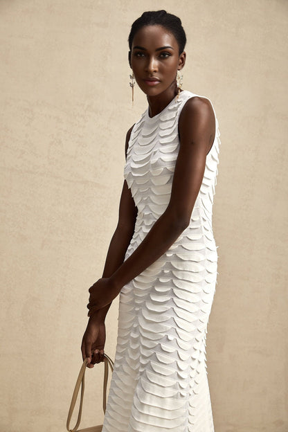 A floorlength snakepattern dress with a fitted bodice and flared skirt featuring godet inserts creating a flowing silhouette