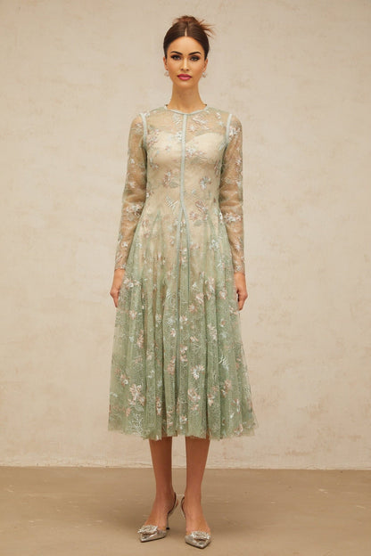 A green pleated midi dress with floral embroidery featuring a design called Philomene