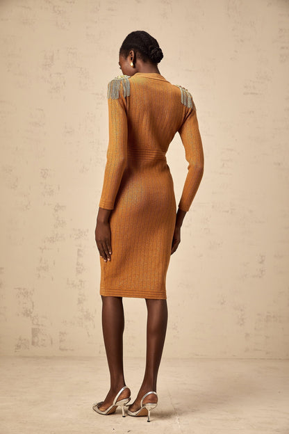 Woman wearing a navy blue ribbed knit midi dress with epaulet details on the shoulders fitted silhouette and long sleeves