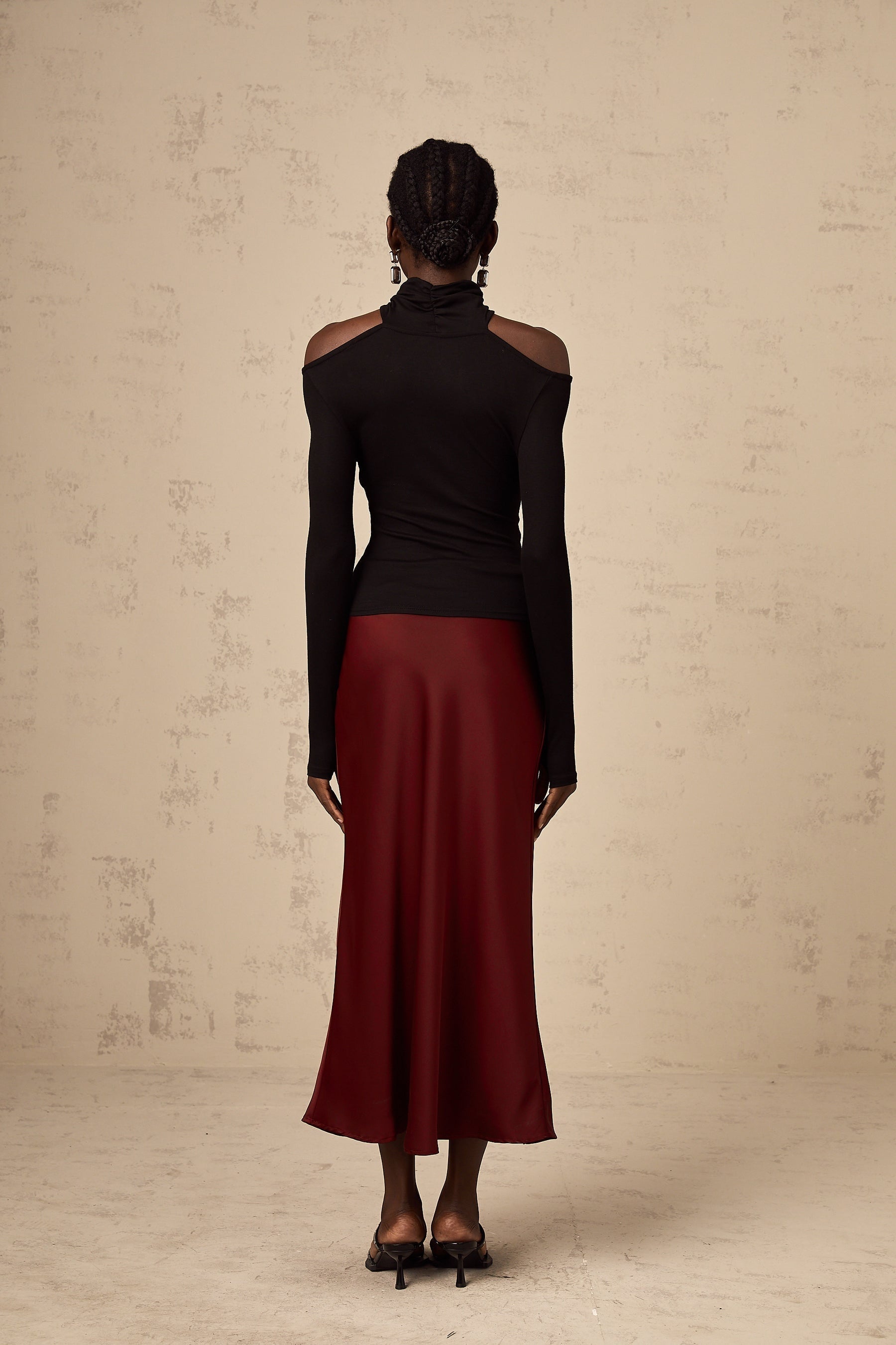 A red satin skirt with a flared silhouette named Vanessa