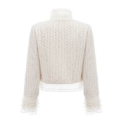 Cropped white jacket with beaded detailing and ruffle trim