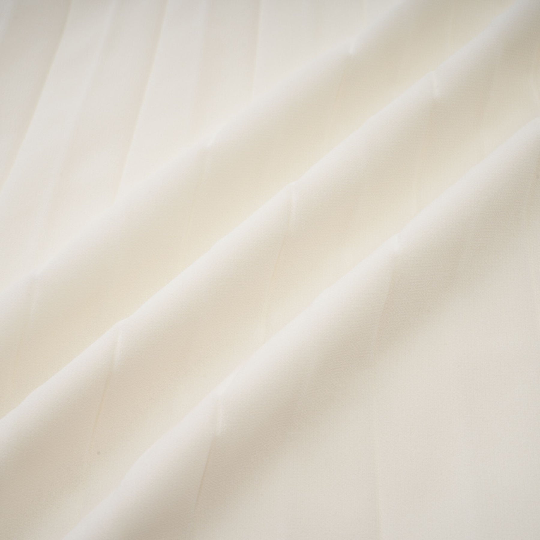Woman wearing white pleated jacket and matching dress with embellishments Blanche set
