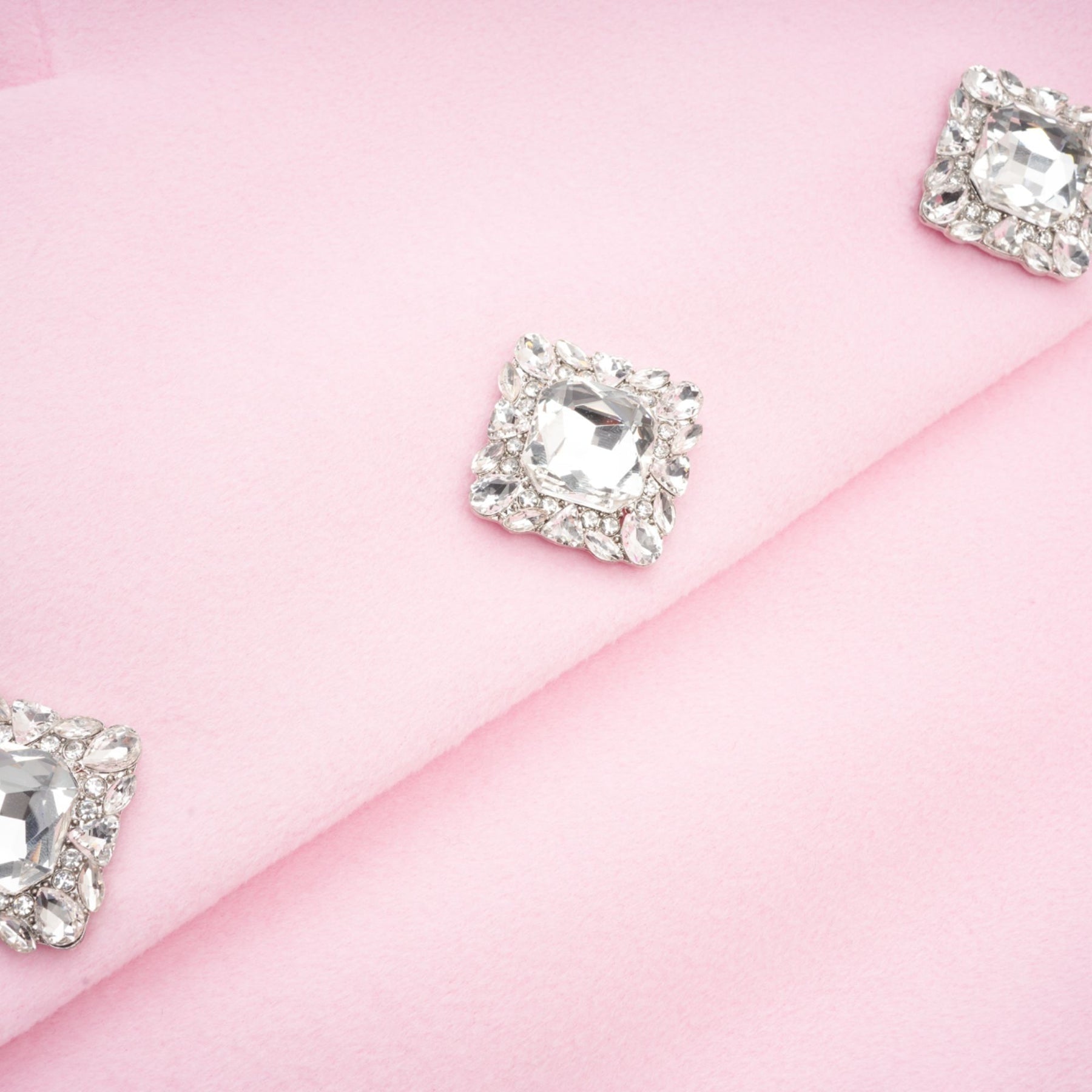 A pink overcoat made of faux fur named Louisette shown on a plain background