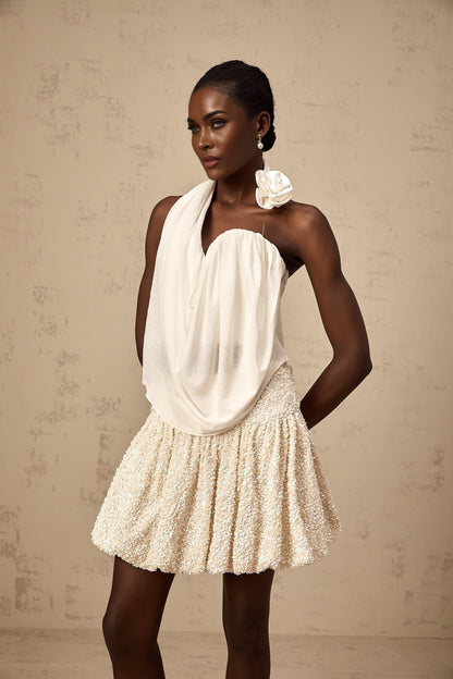 A white halterneck top with floral appliques called Maeva
