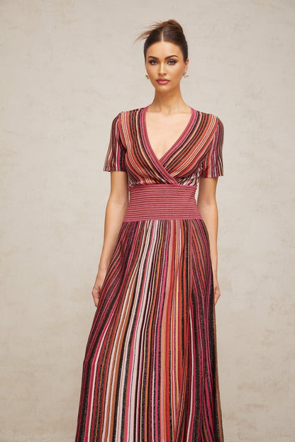 A long flowing maxi dress with a multicolored metallic knit pattern featuring various shimmering hues