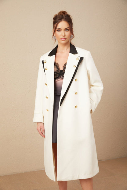 A long wool blazer with color blocking featuring a doublebreasted front in terebinth green and contrasting colors