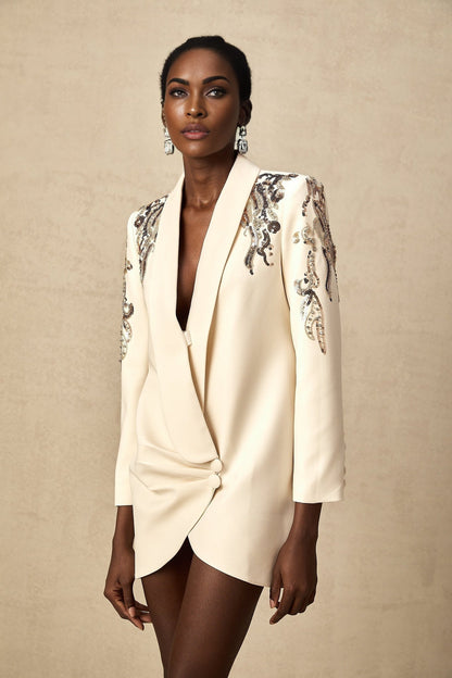 Woman wearing a blazer dress with sparkly sequin embellishments