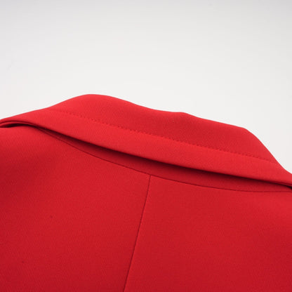 A red doublebreasted blazer with an hourglass silhouette featuring a fitted waist and structured shoulders