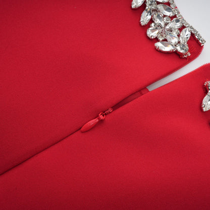 A red mini dress with pleated skirt and embellished details named Leonie