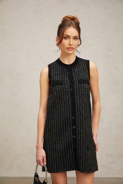 A black mini dress with vertical stripes and sequin embellishments featuring a knit fabric and a design inspired by Zelda