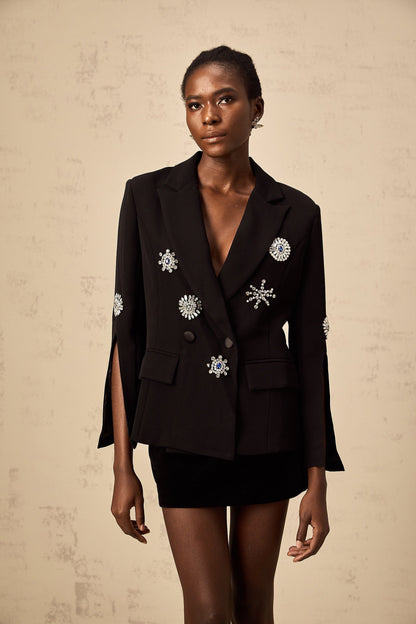 A black blazer with crystal embellishments and slit cuffs