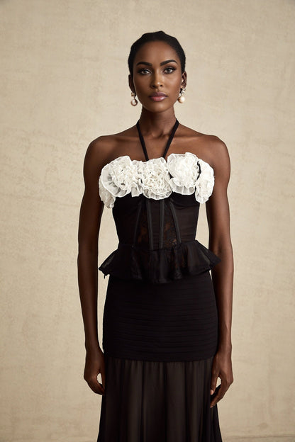 A black lace corset top with faux flower details and intricate floral patterns