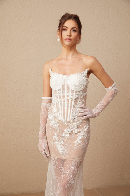 A long white tulle maxi dress with a corset bodice featuring colorful floral embroidery and thin straps